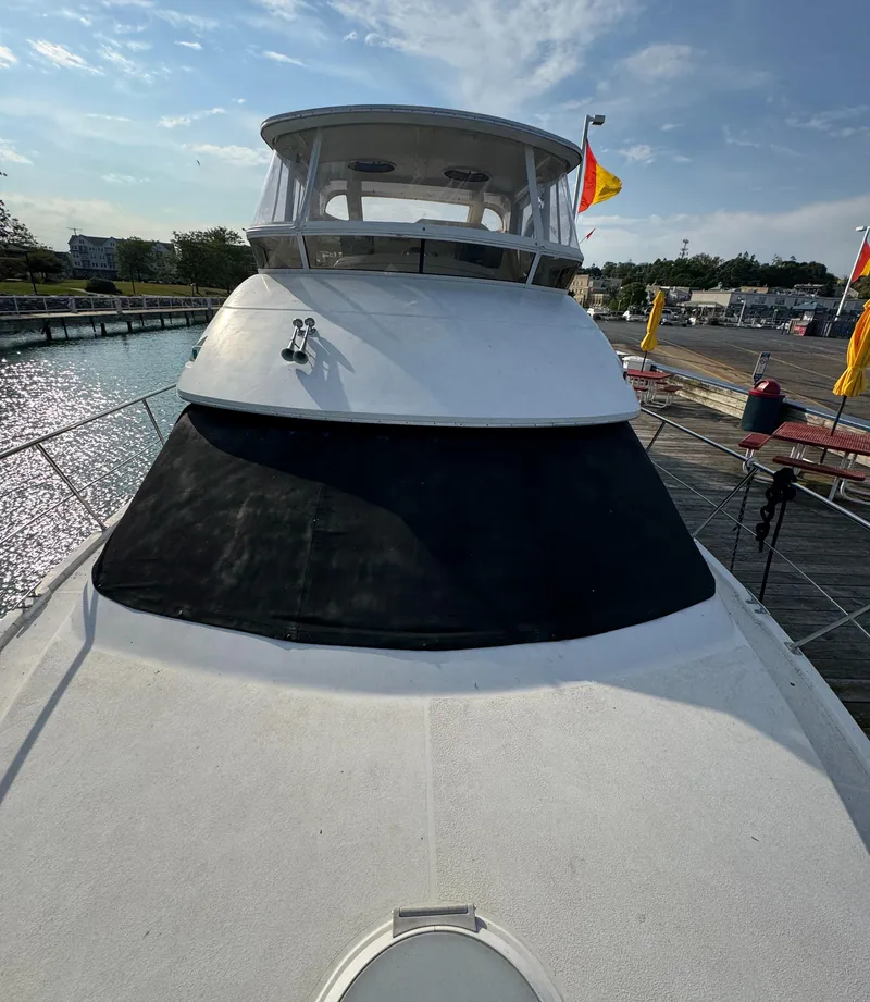 Slide: The Image of 2000 Carver 504 Cockpit Motor Yacht docked at marina under clear sky. - 8