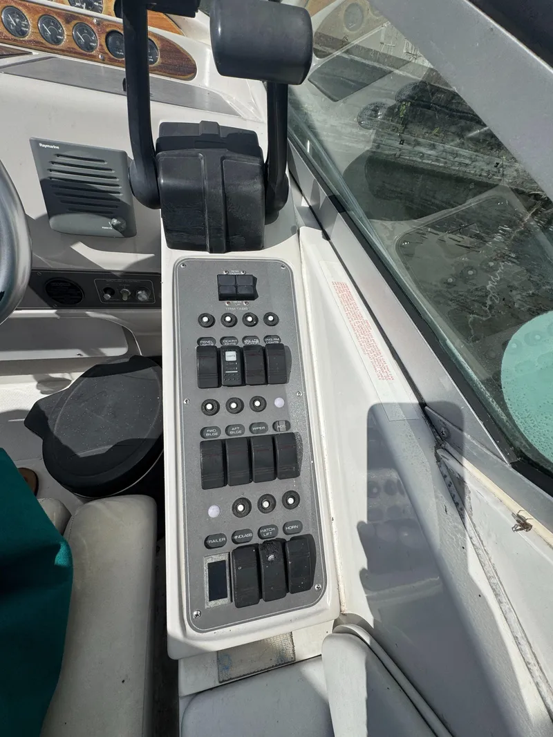 Slide: The Image of Control panel of a 1994 Regal 322 Commodore boat with various switches and levers. - 10