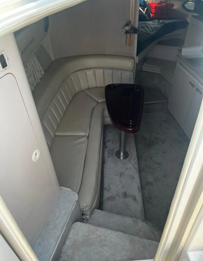 Slide: The Image of Interior of 1994 Regal 322 Commodore boat with beige seating and compact table. - 15