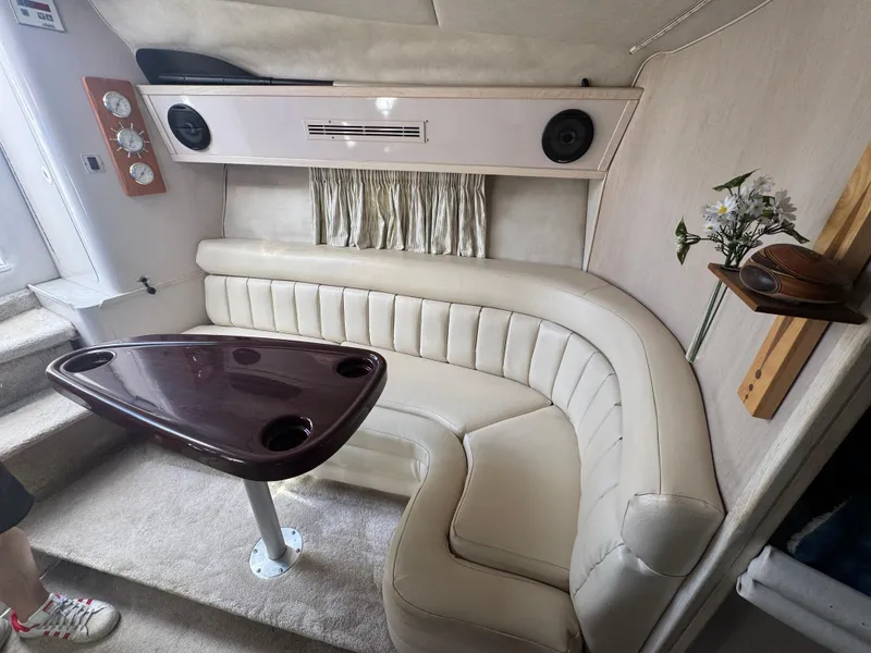 Slide: The Image of 1994 Regal 322 Commodore interior with curved seating and wooden table. - 17
