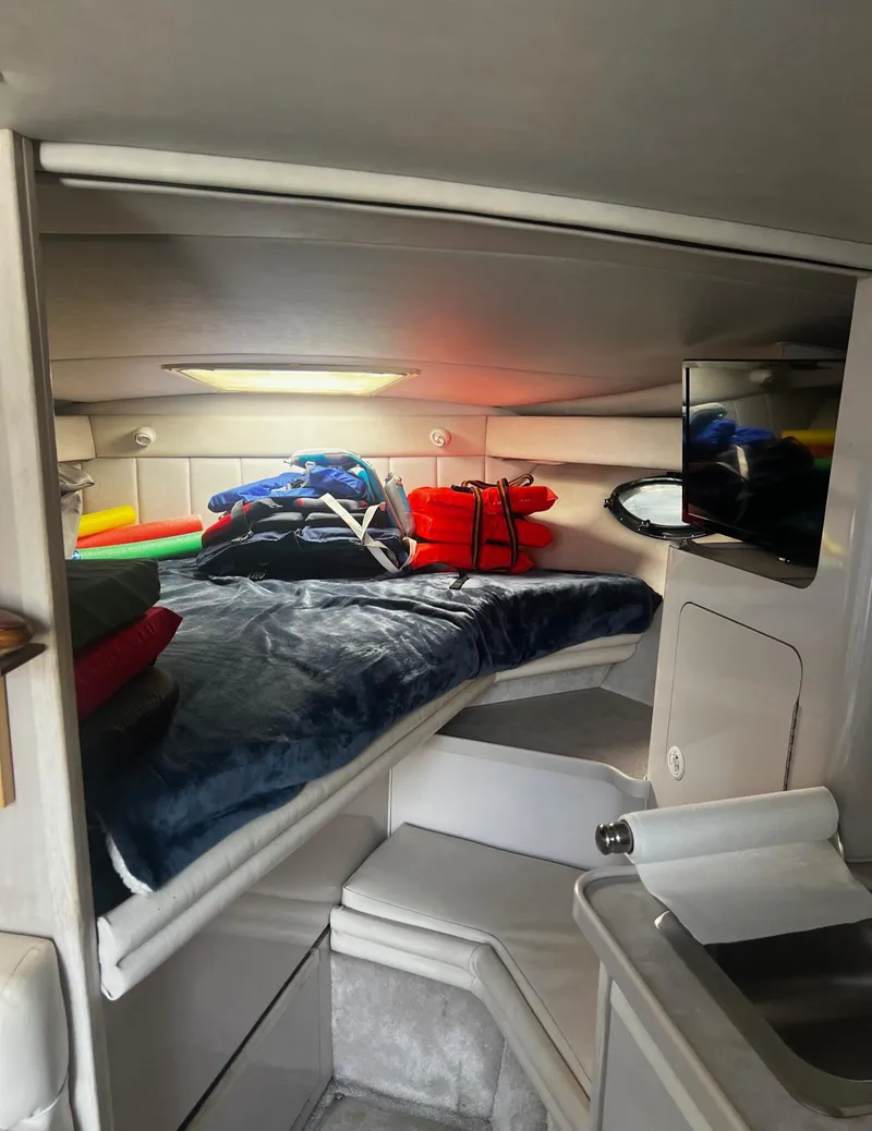 Slide: The Image of 1994 Regal 322 Commodore cabin interior with bed and storage space. - 18