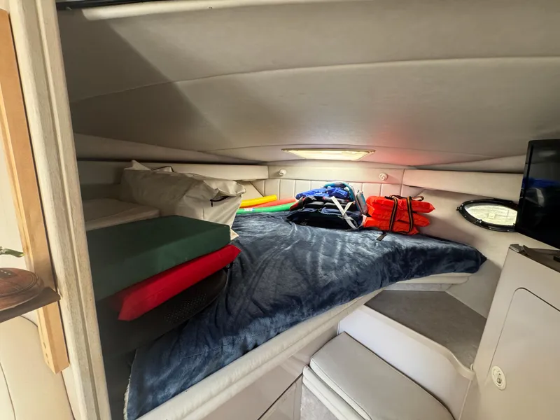 Slide: The Image of 1994 Regal 322 Commodore cabin interior with bed, pillows, and life jackets. - 19