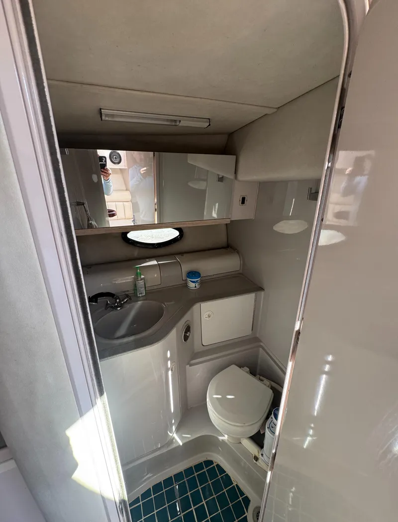 Slide: The Image of 1994 Regal 322 Commodore boat bathroom with sink, toilet, and mirror. - 22