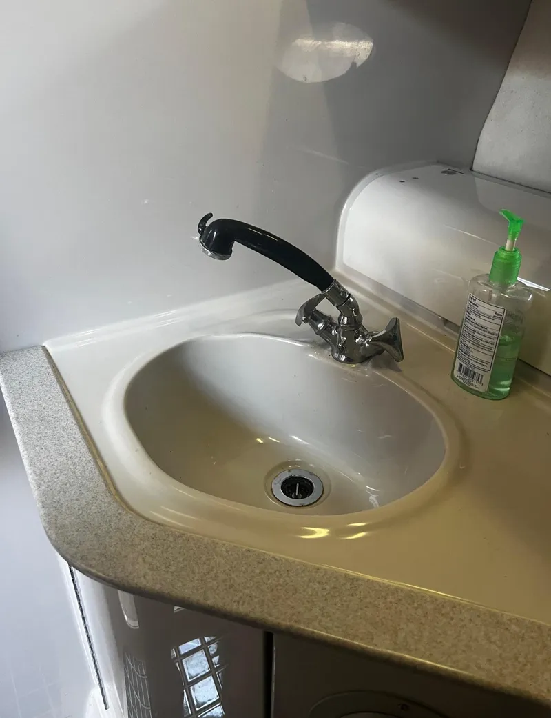 Slide: The Image of 1994 Regal 322 Commodore boat sink with faucet and hand sanitizer. - 24
