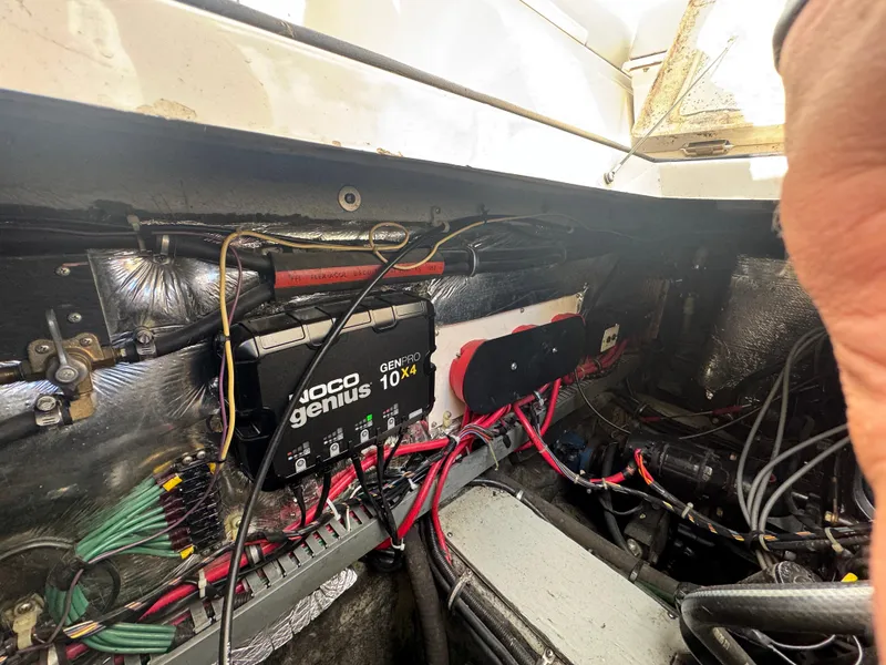 Slide: The Image of Engine compartment of a 1994 Regal 322 Commodore with wiring and battery charger. - 29