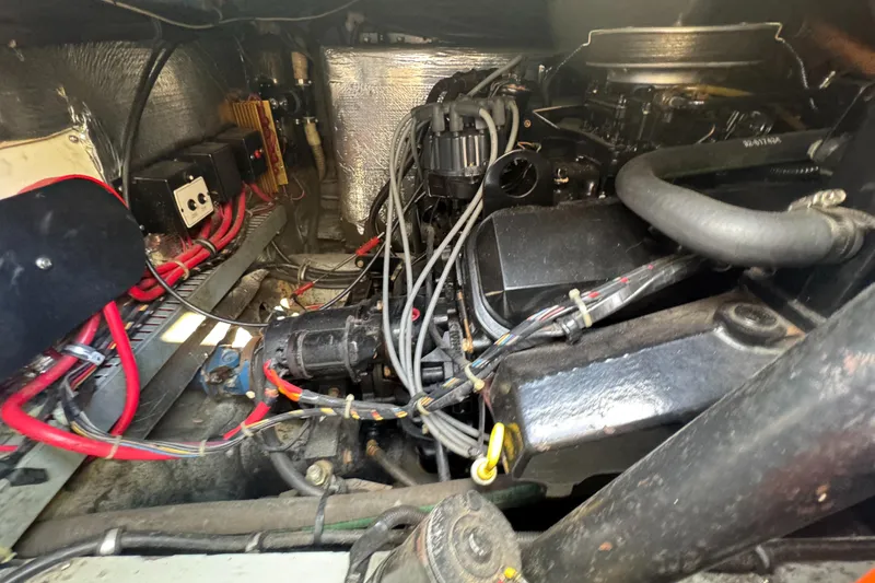 Slide: The Image of Engine compartment of a 1994 Regal 322 Commodore boat, showcasing wiring and components. - 30