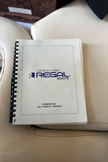 Slide: The Image of 1994 Regal 322 Commodore owner's manual on beige seat. - 34
