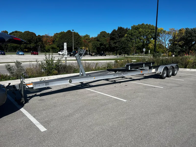 Slide: The Image of Triple-axle boat trailer in parking lot, suitable for 1994 Regal 322 Commodore. - 35