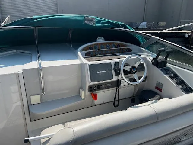 Slide: The Image of 1994 Regal 322 Commodore boat cockpit with steering wheel and control panel. - 4