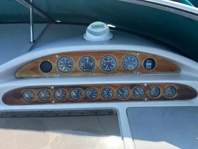 Slide: The Image of Dashboard of a 1994 Regal 322 Commodore boat with wooden panel and gauges. - 6