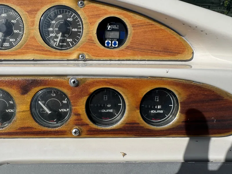 Slide: The Image of 1994 Regal 322 Commodore dashboard with wooden panel and gauges. - 8