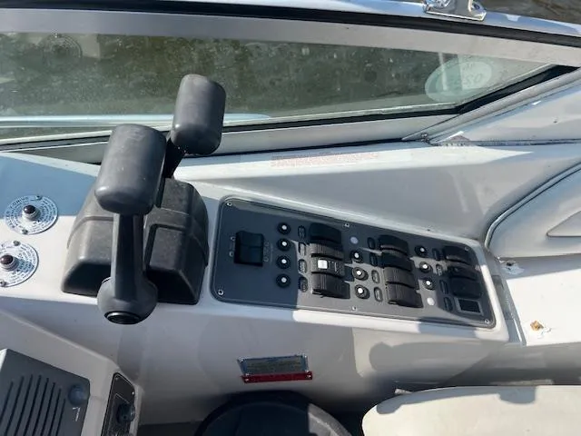 Slide: The Image of Control panel of a 1994 Regal 322 Commodore boat with levers and switches. - 9