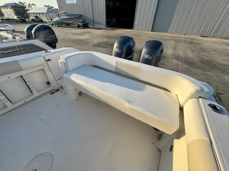 Slide: The Image of 2008 Century 2400 Walkaround boat with seating and dual outboard engines in a marina setting. - 10