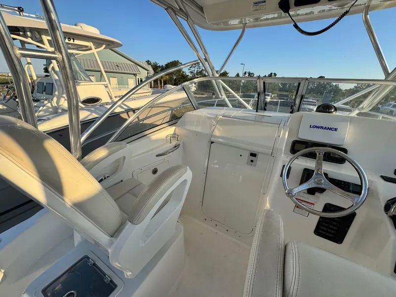 Slide: The Image of 2008 Century 2400 Walkaround boat interior with steering wheel and seating. - 13