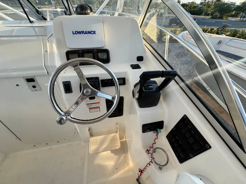 Slide: The Image of Century 2400 Walkaround 2008 boat helm with steering wheel and Lowrance navigation system. - 14