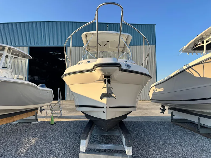 Slide: The Image of 2008 Century 2400 Walkaround boat on trailer, parked outside a large blue warehouse. - 7