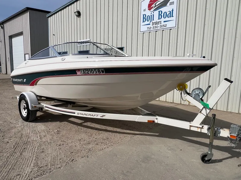 Slide: The Image of 1997 Starcraft 1810 boat on trailer, parked outside Boji Boat brokers building. - 1
