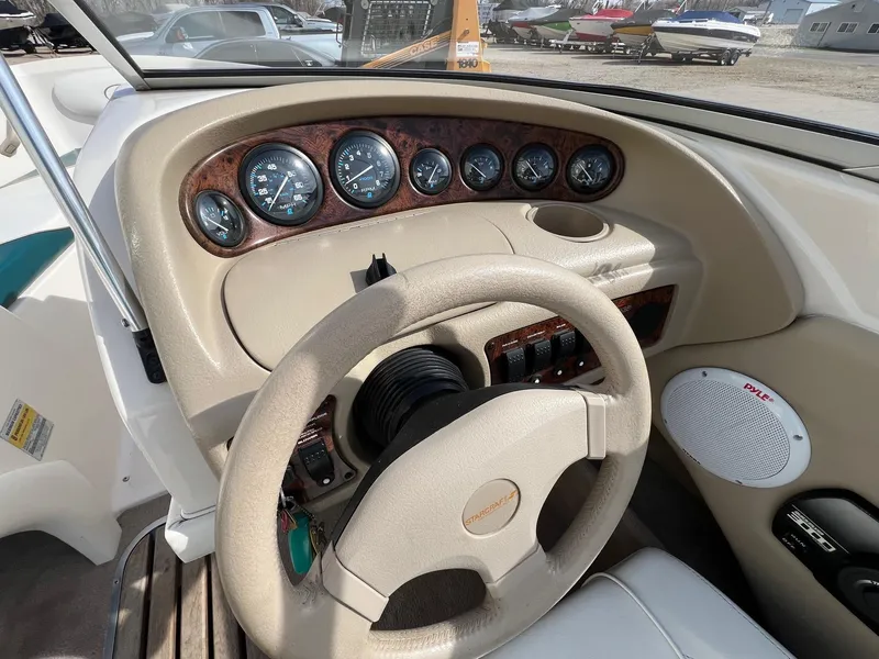 Slide: The Image of Dashboard of a 1997 Starcraft 1810 boat with gauges and steering wheel. - 10
