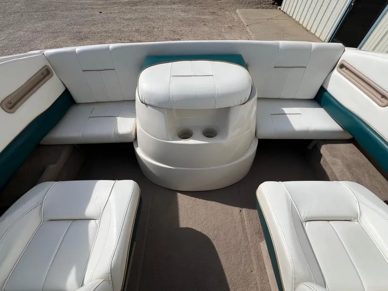 Slide: The Image of Interior of a 1997 Starcraft 1810 boat with white and teal seating. - 15