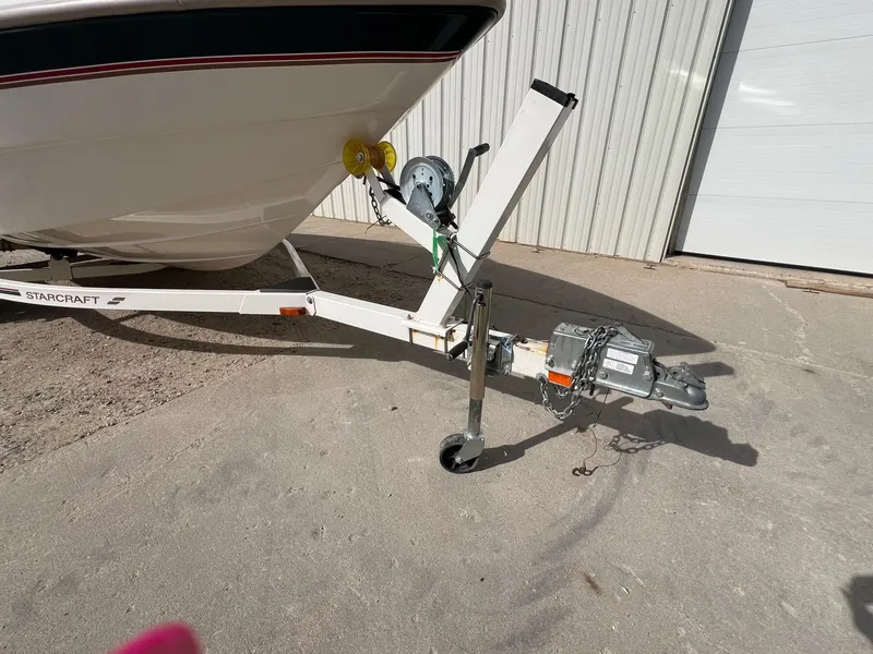 Slide: The Image of 1997 Starcraft 1810 boat trailer hitch and winch on concrete surface. - 19