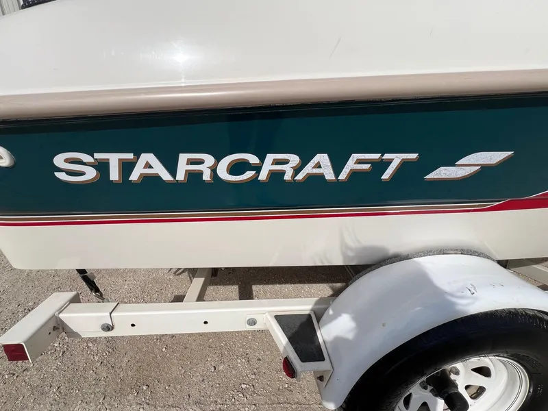 Slide: The Image of 1997 Starcraft 1810 boat trailer with logo, white and green design. - 3