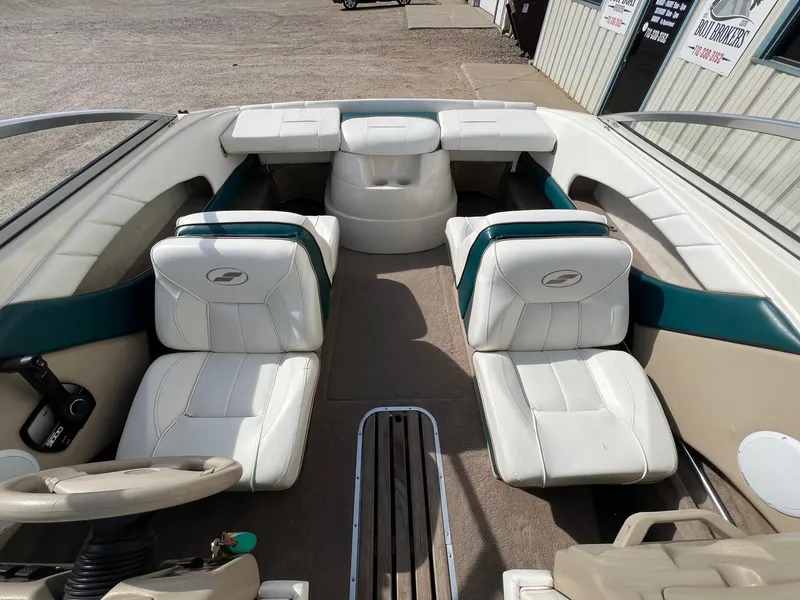 Slide: The Image of Interior of a 1997 Starcraft 1810 boat with white and teal seating. - 8