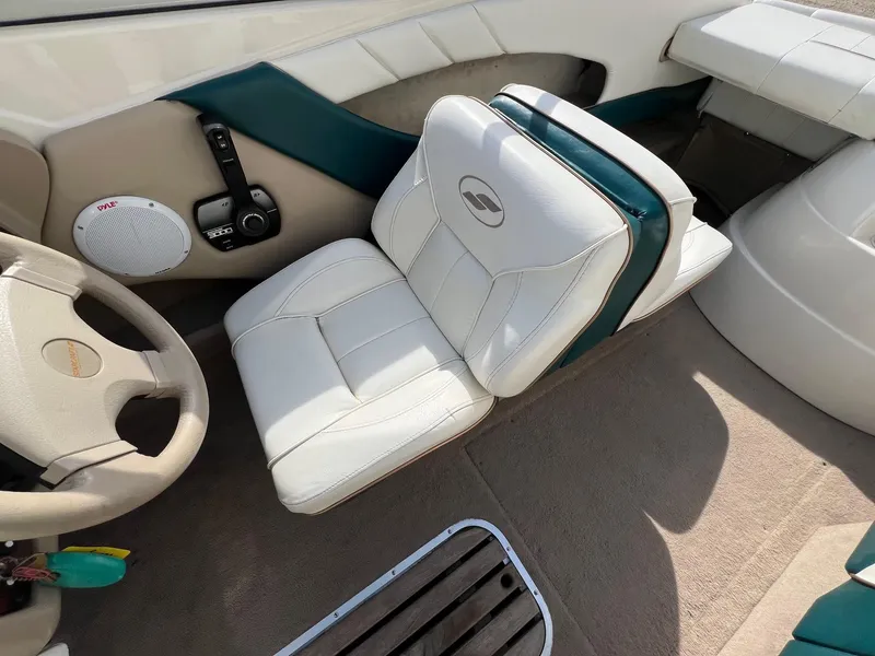 Slide: The Image of Interior of a 1997 Starcraft 1810 boat with white and teal seating. - 9
