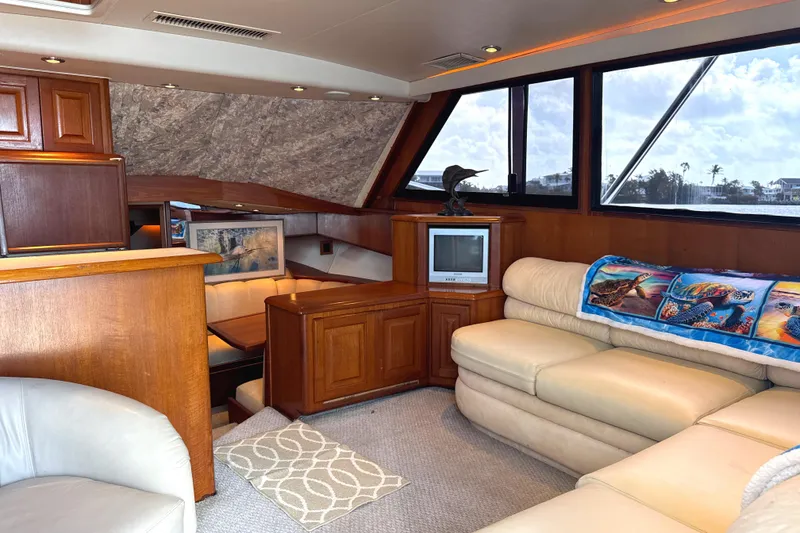 Slide: The Image of Luxurious interior of 1990 Viking 38 Convertible yacht with leather seating and wood cabinetry. - 11