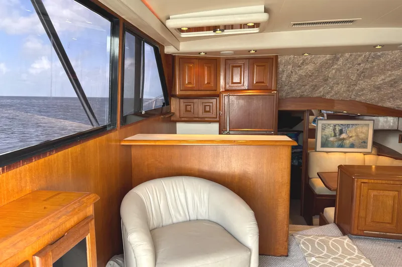 Slide: The Image of Interior of 1990 Viking 38 Convertible yacht with wood paneling and ocean view. - 12