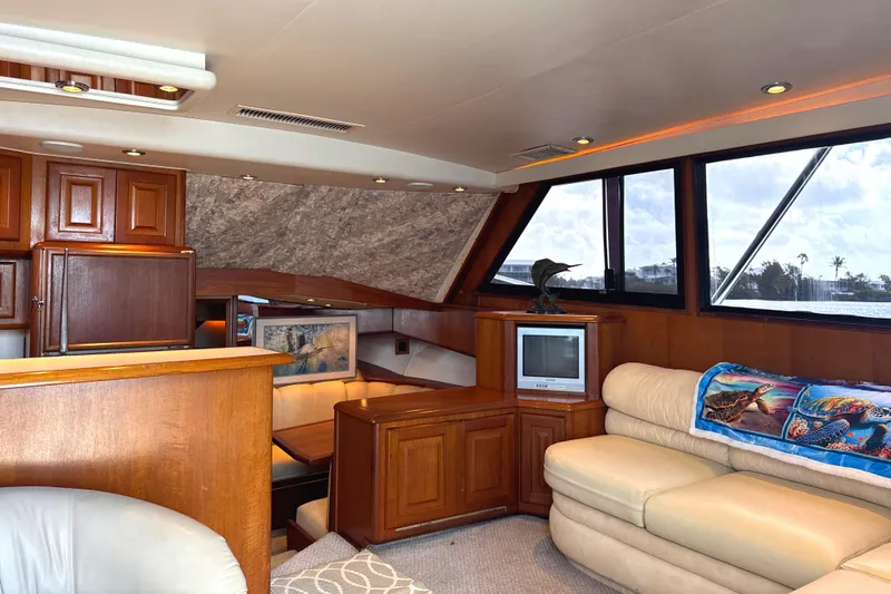 Slide: The Image of Luxurious interior of a 1990 Viking 38 Convertible yacht with wood cabinetry and plush seating. - 13