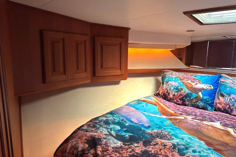 Slide: The Image of Cozy bedroom in 1990 Viking 38 Convertible yacht with ocean-themed bedding. - 17