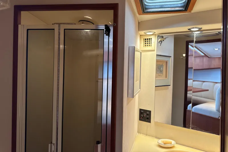 Slide: The Image of Interior of 1990 Viking 38 Convertible yacht, featuring a shower and vanity area. - 21