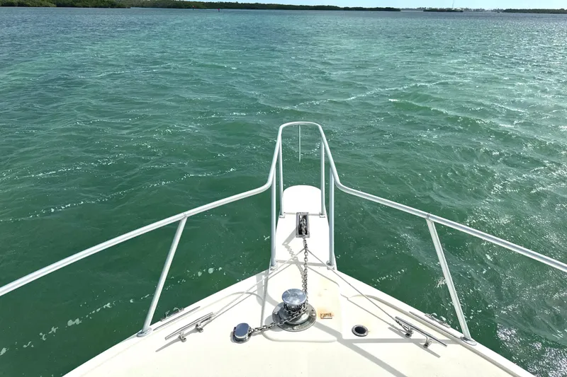 Slide: The Image of Bow view of 1990 Viking 38 Convertible yacht on open water. - 25