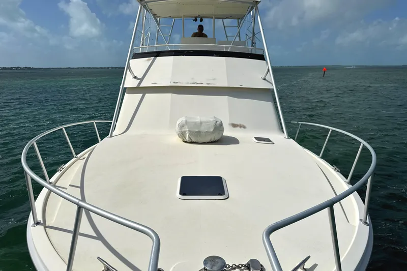 Slide: The Image of 1990 Viking 38 Convertible yacht on open water, viewed from the bow. - 26