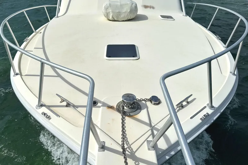 Slide: The Image of Bow of 1990 Viking 38 Convertible boat with anchor chain on open water. - 28