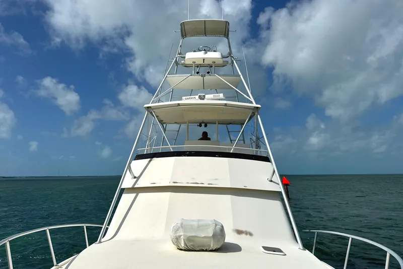 Slide: The Image of 1990 Viking 38 Convertible yacht on open sea under blue sky. - 29