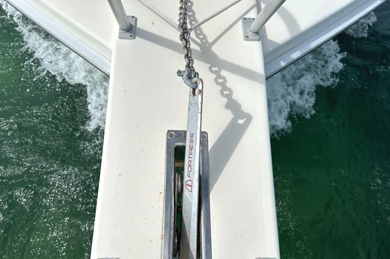 Slide: The Image of Bow of 1990 Viking 38 Convertible with anchor chain over water. - 30