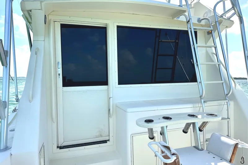 Slide: The Image of 1990 Viking 38 Convertible yacht with fishing rod holders and ladder on deck. - 32