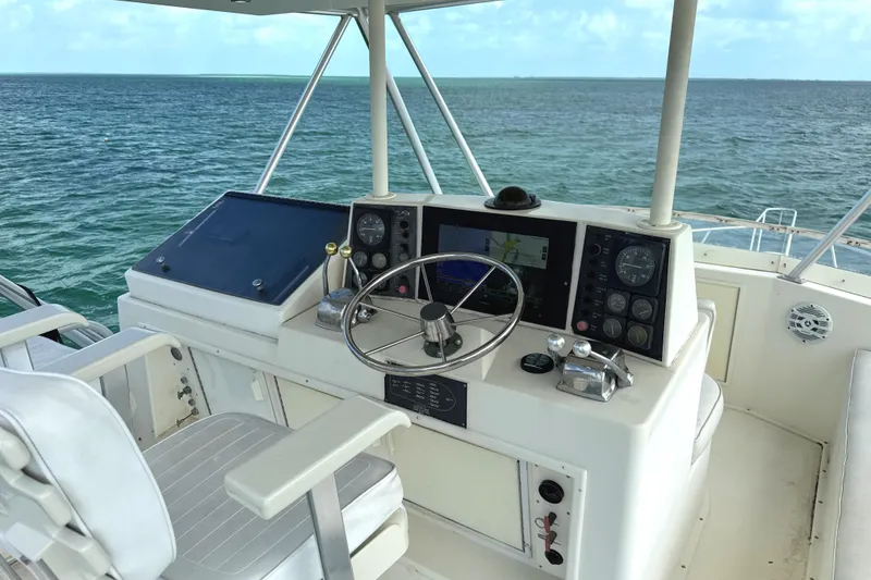 Slide: The Image of Helm of 1990 Viking 38 Convertible yacht with ocean view. - 36