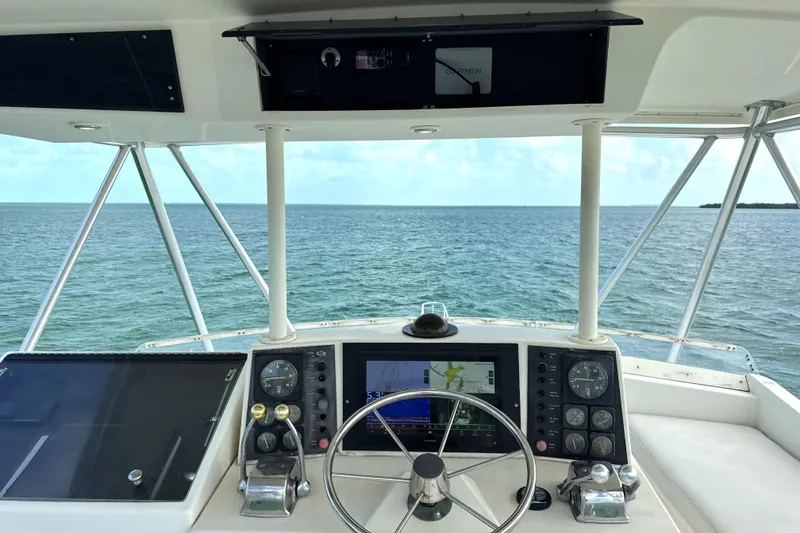 Slide: The Image of Cockpit view of 1990 Viking 38 Convertible yacht with ocean backdrop. - 37