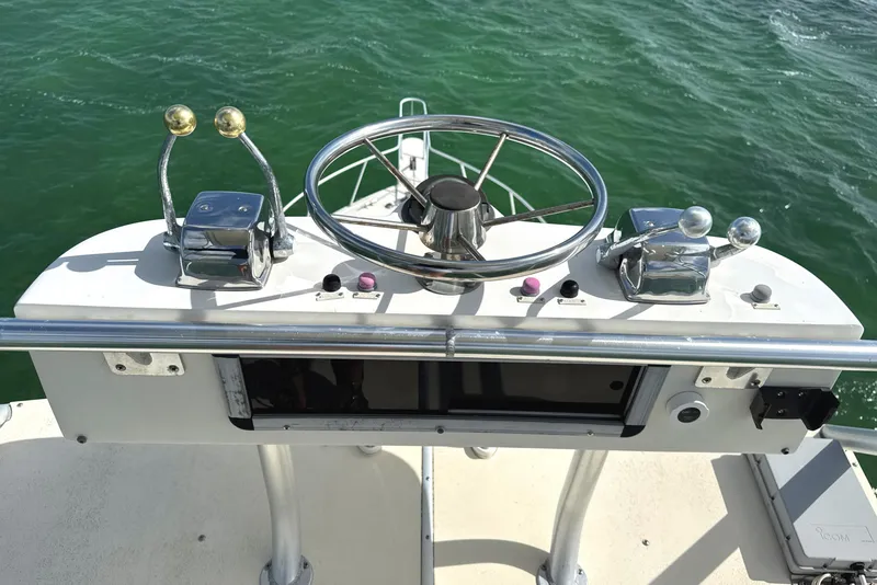 Slide: The Image of Control panel of a 1990 Viking 38 Convertible boat on water. - 43