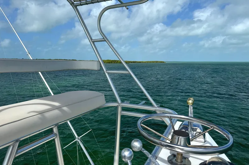 Slide: The Image of 1990 Viking 38 Convertible yacht helm with ocean view and clear skies. - 45