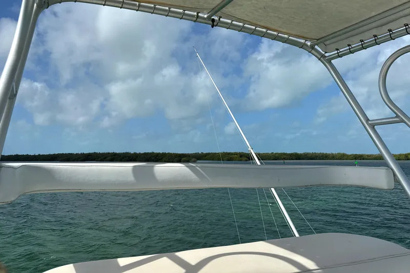Slide: The Image of View from a 1990 Viking 38 Convertible boat, overlooking calm waters and a cloudy sky. - 46