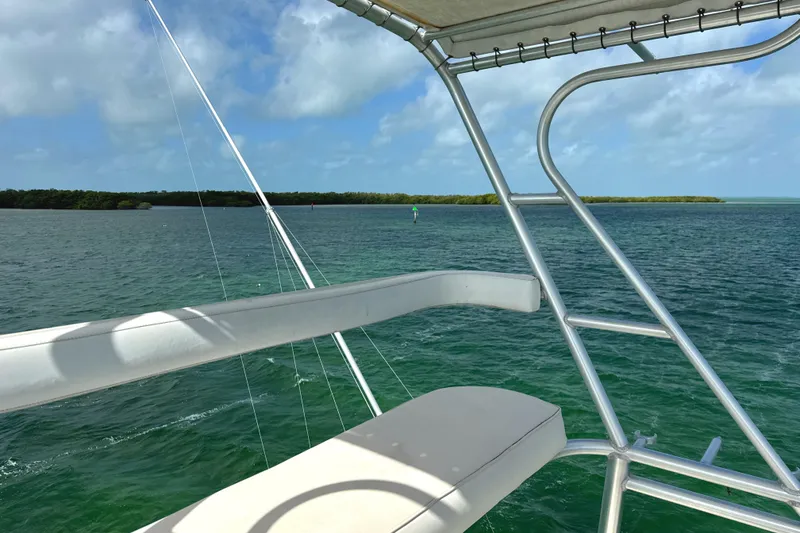 Slide: The Image of View from a 1990 Viking 38 Convertible boat overlooking calm blue waters. - 48