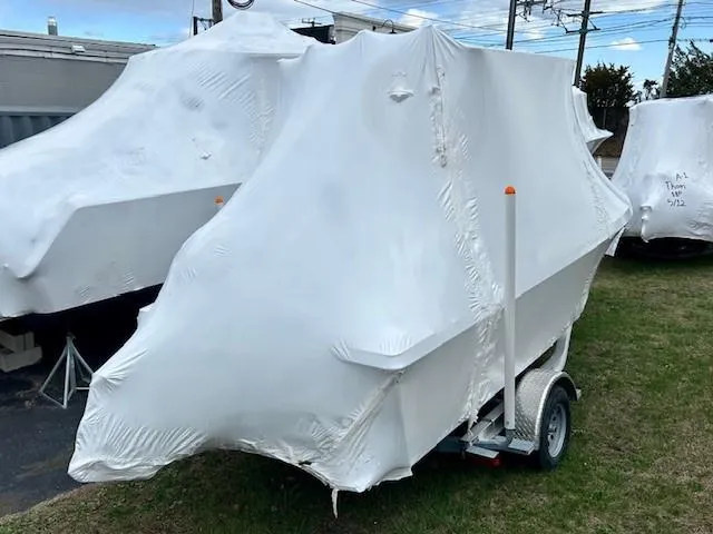 Slide: The Image of 2024 Parker 1801 Center Console boat covered in protective wrap on a trailer. - 3