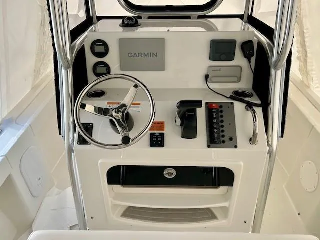 Slide: The Image of 2024 Parker 1801 Center Console boat dashboard with Garmin navigation system and steering wheel. - 9
