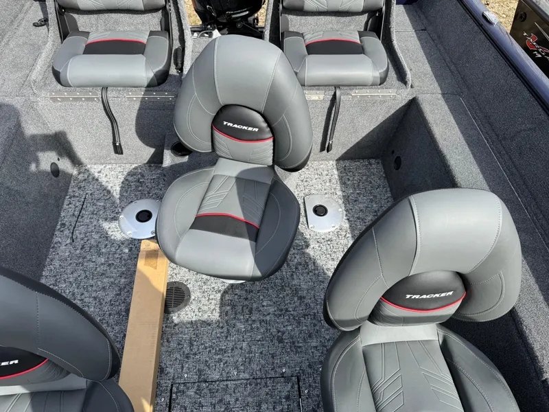 Slide: The Image of 2025 Tracker Pro Guide V-175 Combo boat interior with gray seating and carpeted flooring. - 13