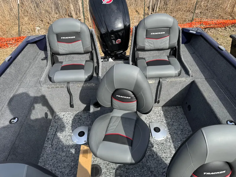 Slide: The Image of 2025 Tracker Pro Guide V-175 Combo boat interior with gray seating and motor. - 16