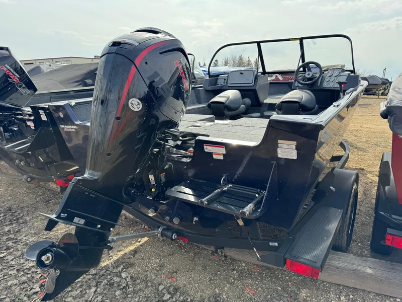 Slide: The Image of 2025 Tracker Pro Guide V-175 Combo boat with outboard motor, parked on a trailer. - 3