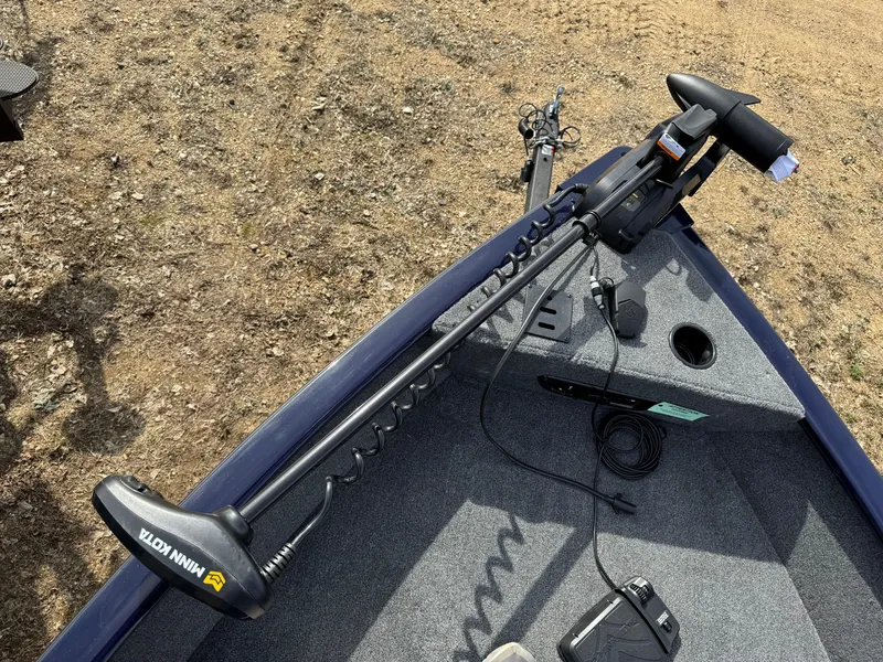 Slide: The Image of 2025 Tracker Pro Guide V-175 Combo boat with Minn Kota trolling motor on deck. - 4